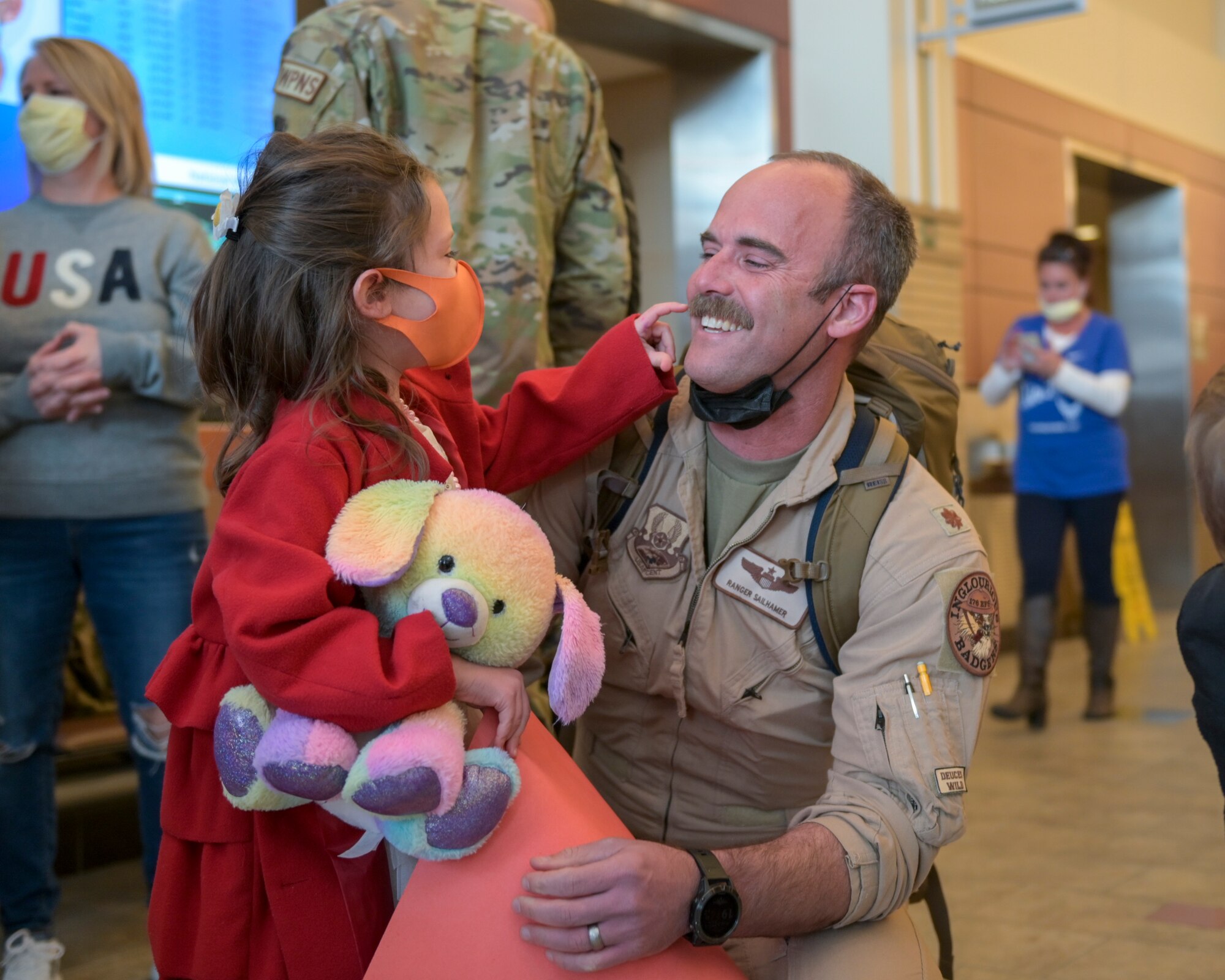 U.S. Air Force Maj. Peter Sailhamer, an F-16 Fighting Falcon pilot assigned to the 115th Fighter Wing, Madison, Wisconsin is greeted with excitement by family after arriving home from an overseas deployment Jan. 13, 2022 at Dane County Regional Airport. Sailhamer was with approximately 300 other Airmen from the 115th FW that deployed to Prince Sultan Air Base, Saudi Arabia. (U.S. Air National Guard photo by Staff Sgt. Cameron Lewis)