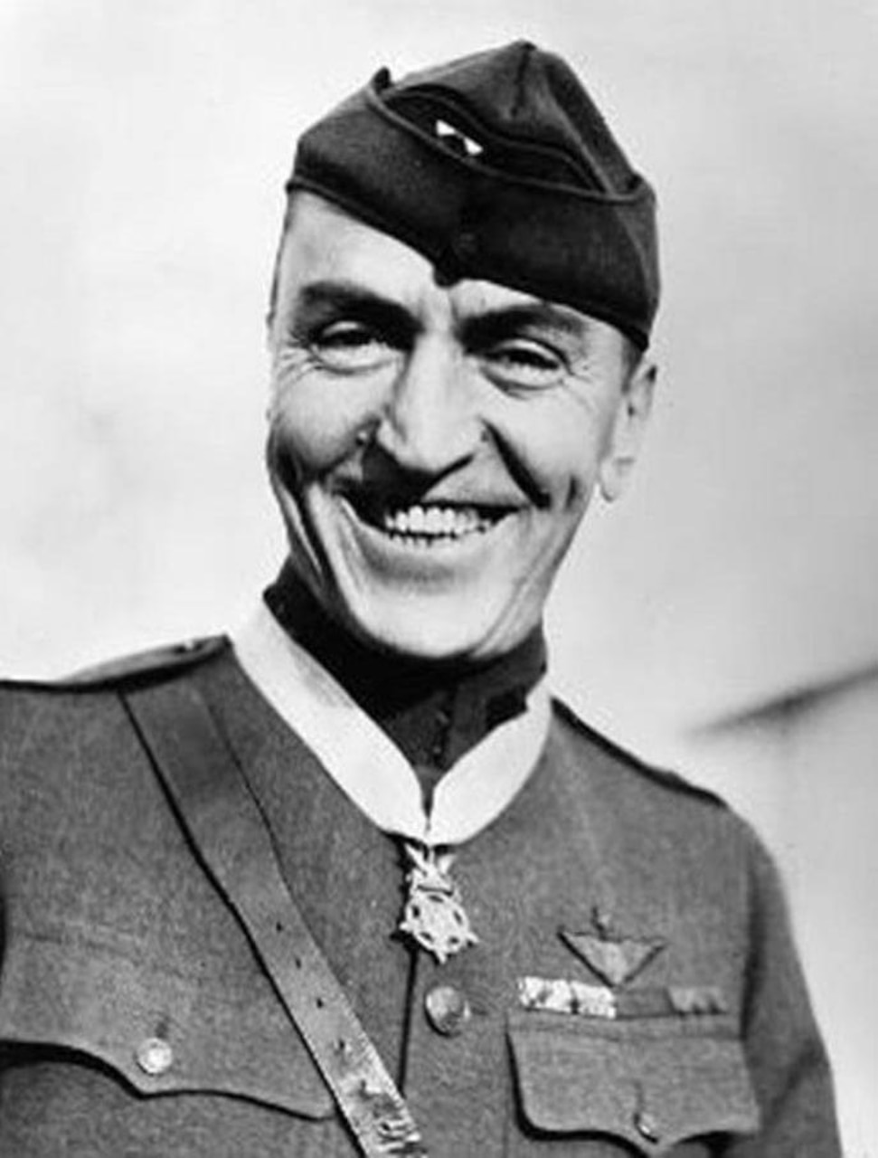 A smiling soldier poses for a photo while wearing the Medal of Honor.