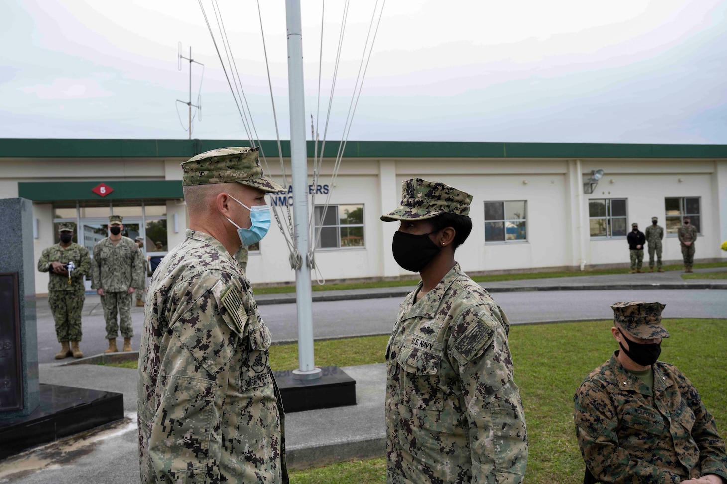 220118-N-PQ586-1004 OKINAWA, Japan (Jan. 18, 2022) Cmdr. Andrew Olsen, Naval Mobile Construction Battalion (NMCB) 5’s commanding officer, transfers authority to Cmdr. LaKeeva Gunderson, NMCB-3's commanding officer, during a relief in place/transfer of authority (RIP/TOA) ceremony onboard Camp Shields in Okinawa, Jan. 18. This RIP/TOA marked the official completion of NMCB-5's deployment in the region. NMCB-5 is homeported in Port Hueneme, California. The Seabees will train on high-quality construction, expeditionary logistics, and combat operations during the homeport phase. They execute construction and engineering projects to support Major Combat Operations, disaster response, and humanitarian assistance. (U.S. Navy photo by Mass Communication Specialist 2nd Class Jessica Ann Hattell)