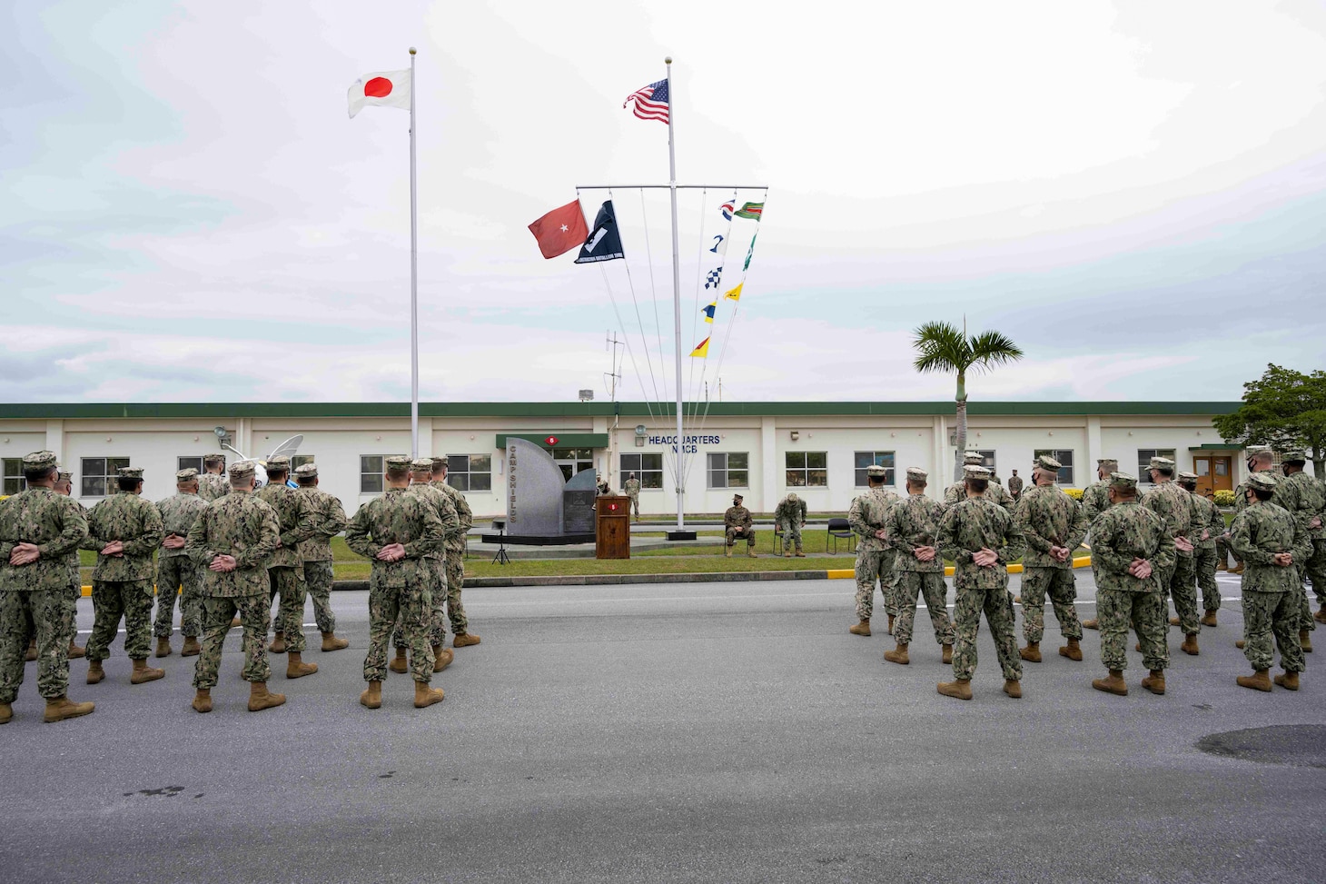 220118-N- PQ586-1005 OKINAWA, Japan (Jan. 18, 2022) U.S. Navy Seabees with Naval Mobile Construction Battalion (NMCB) 3 and NMCB-5 stand at parade rest during a relief in place/transfer of authority (RIP/TOA) ceremony onboard Camp Shields in Okinawa, Jan. 18. This RIP/TOA marked the official completion of NMCB-5's deployment in the region. NMCB-5 is homeported in Port Hueneme, California. The Seabees will train on high-quality construction, expeditionary logistics, and combat operations during the homeport phase. They execute construction and engineering projects to support Major Combat Operations, disaster response, and humanitarian assistance. (U.S. Navy photo by Mass Communication Specialist 2nd Class Jessica Ann Hattell)
