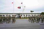 220118-N- PQ586-1005 OKINAWA, Japan (Jan. 18, 2022) U.S. Navy Seabees with Naval Mobile Construction Battalion (NMCB) 3 and NMCB-5 stand at parade rest during a relief in place/transfer of authority (RIP/TOA) ceremony onboard Camp Shields in Okinawa, Jan. 18. This RIP/TOA marked the official completion of NMCB-5's deployment in the region. NMCB-5 is homeported in Port Hueneme, California. The Seabees will train on high-quality construction, expeditionary logistics, and combat operations during the homeport phase. They execute construction and engineering projects to support Major Combat Operations, disaster response, and humanitarian assistance. (U.S. Navy photo by Mass Communication Specialist 2nd Class Jessica Ann Hattell)