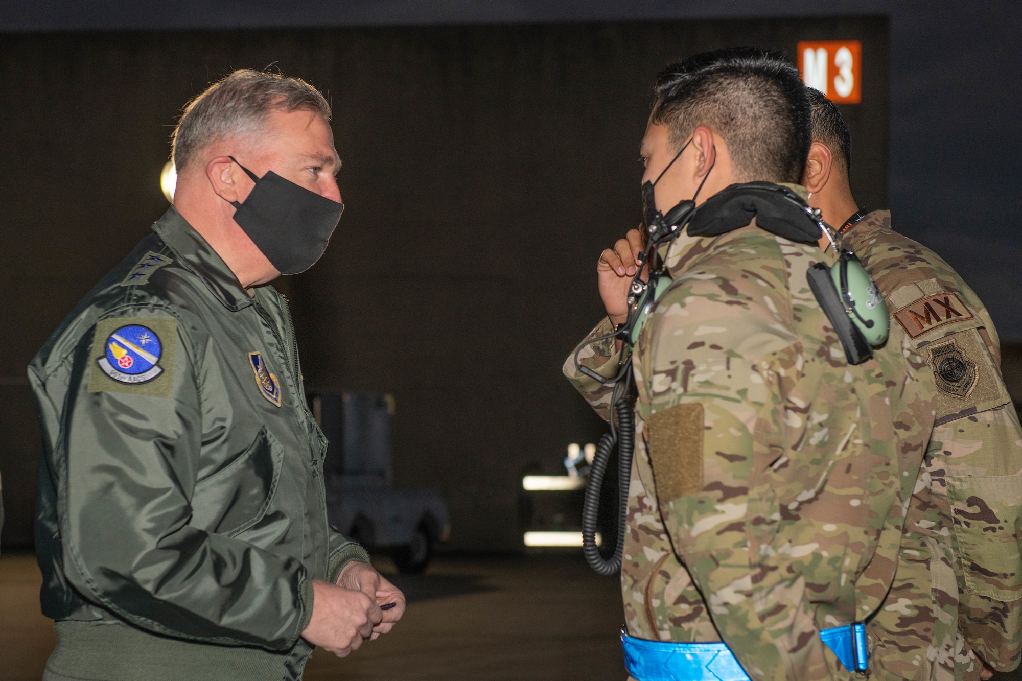 A general receives a patch from a military member