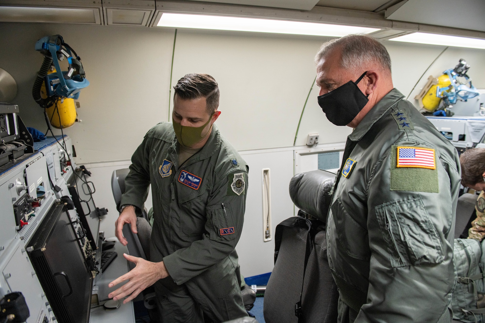 A military member shows a general a new system on board a plane