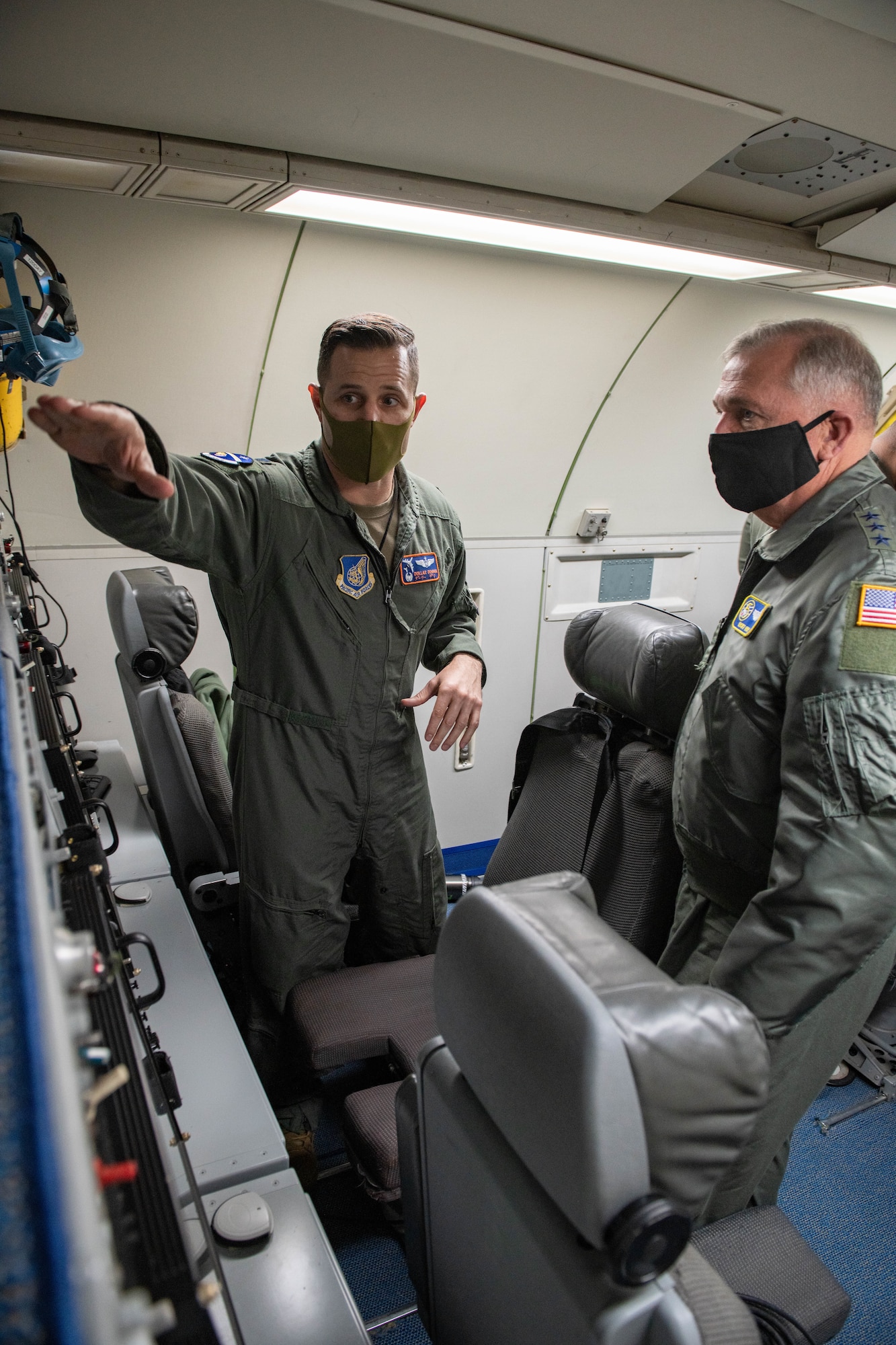 A military member shows a general the new system on board a plane