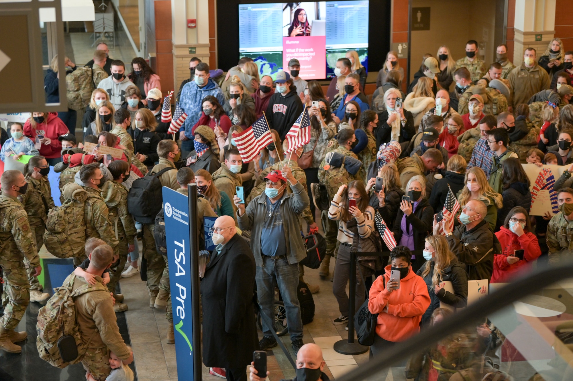 Families and friends greet their Airmen Jan. 13, 2022 at Dane County Regional Airport in Madison, Wisconsin upon their arrival from a three month long deployment. The Wisconsin Air National Guardsmen assigned to the 115th Fighter Wing and their active duty associates were deployed to Prince Sultan Air Base, Saudi Arabia in support of U.S. Central Command Operations. (U.S. Air National Guard photo by Staff Sgt. Cameron Lewis)