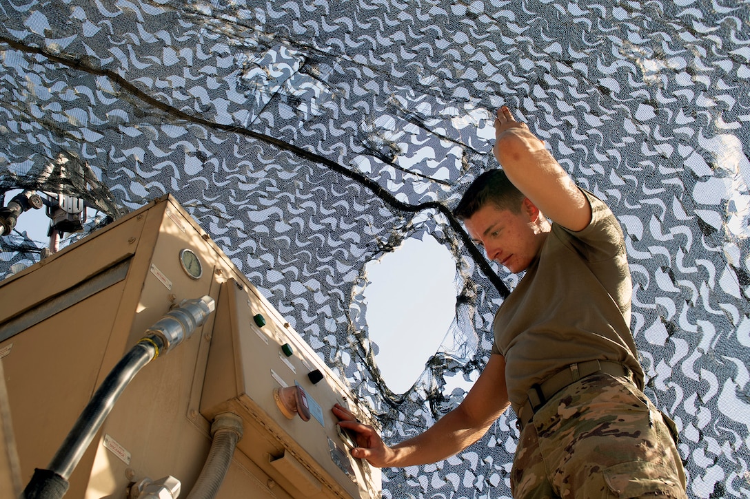 U.S. Army Spc. Corbin Doll, a forward observer with 1st Battalion, 194th Field Artillery, mans a Counter-Rocket, Artillery, Mortar gun at Al Asad Air Base, Iraq, on June 7, 2021. As a forward observer, Doll has been trained to help direct artillery and mortar fire. (U.S. Army National Guard photo by Sgt. 1st Class Christie R. Smith)