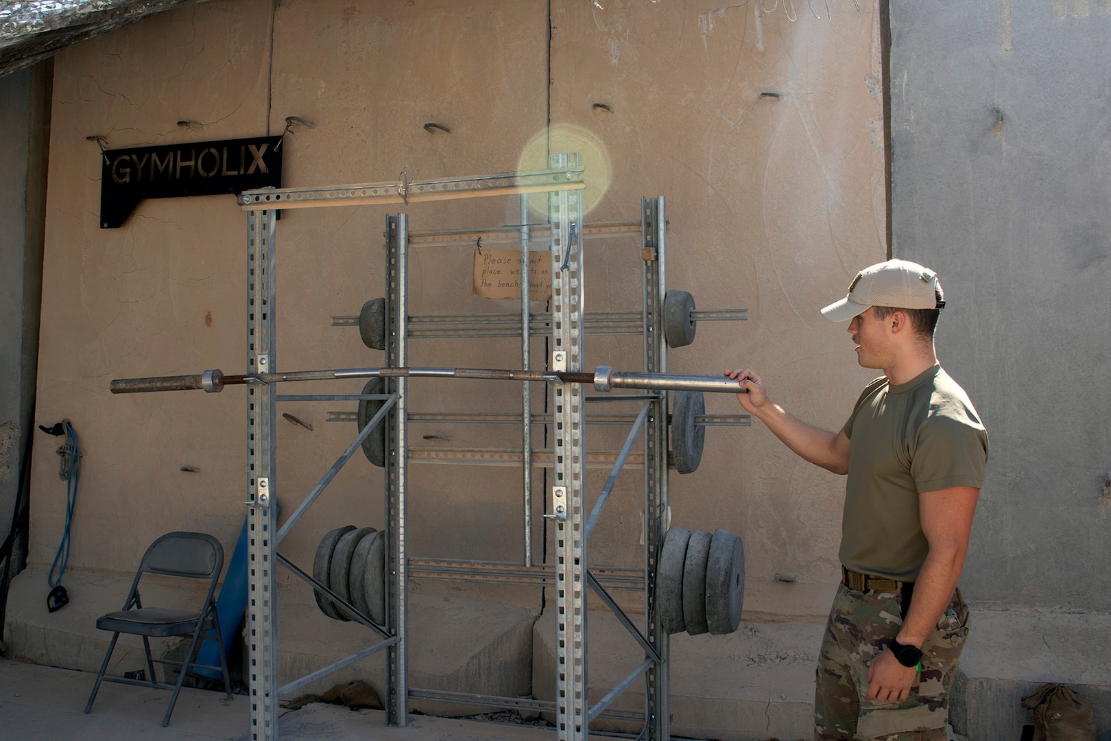 U.S. Army Spc. Kristian Kelly, a small arms artillery repair specialist from the 1st Battalion, 194th Field Artillery, shows off the handmade gym he and his fellow Soldiers built from concrete and scrap materials at the site of their Counter-Rocket, Artillery, Mortar gun at Al Asad Air Base, Iraq, on June 7, 2021. Kelly spent around 2,500 hours inside the small, secure compound, ensuring the operability of the C-RAM as part of a vital air defense mission to protect Al Asad from enemy rockets and drones. (U.S. Army National Guard photo by Sgt. 1st Class Christie R. Smith)