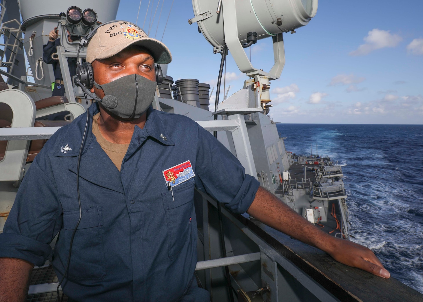 Logistics Specialist Joshua Green, from New Orleans, stands lookout watch on the bridgewing as Arleigh Burke-class guided-missile destroyer USS Benfold (DDG 65) conducts routine underway operations. Benfold is forward-deployed to the U.S. 7th Fleet area of operations in support of a free and open Indo-Pacific.