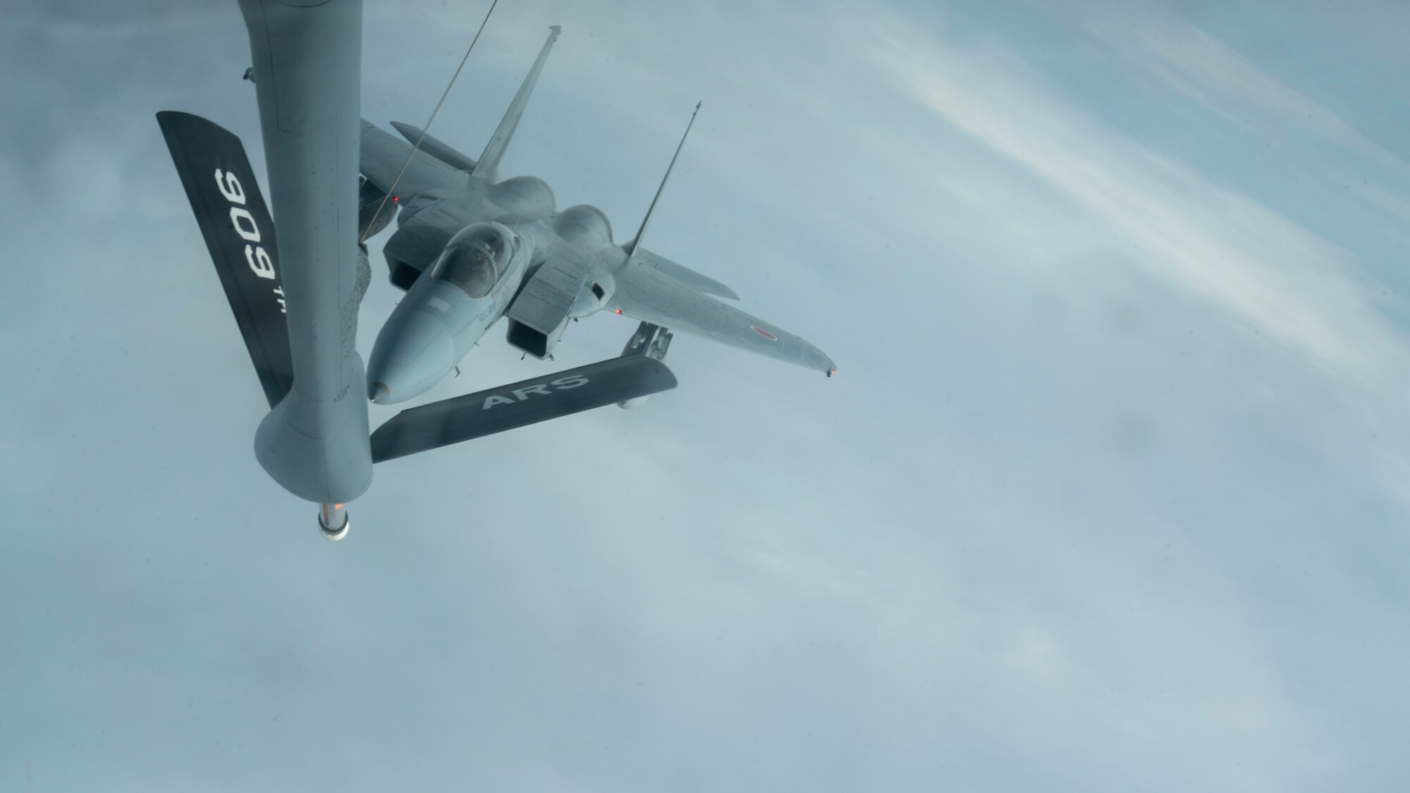 A Japan Air Self-Defense Force F-15J  prepares to receive fuel from a 909th Air Refueling Squadron KC-135 Stratotanker