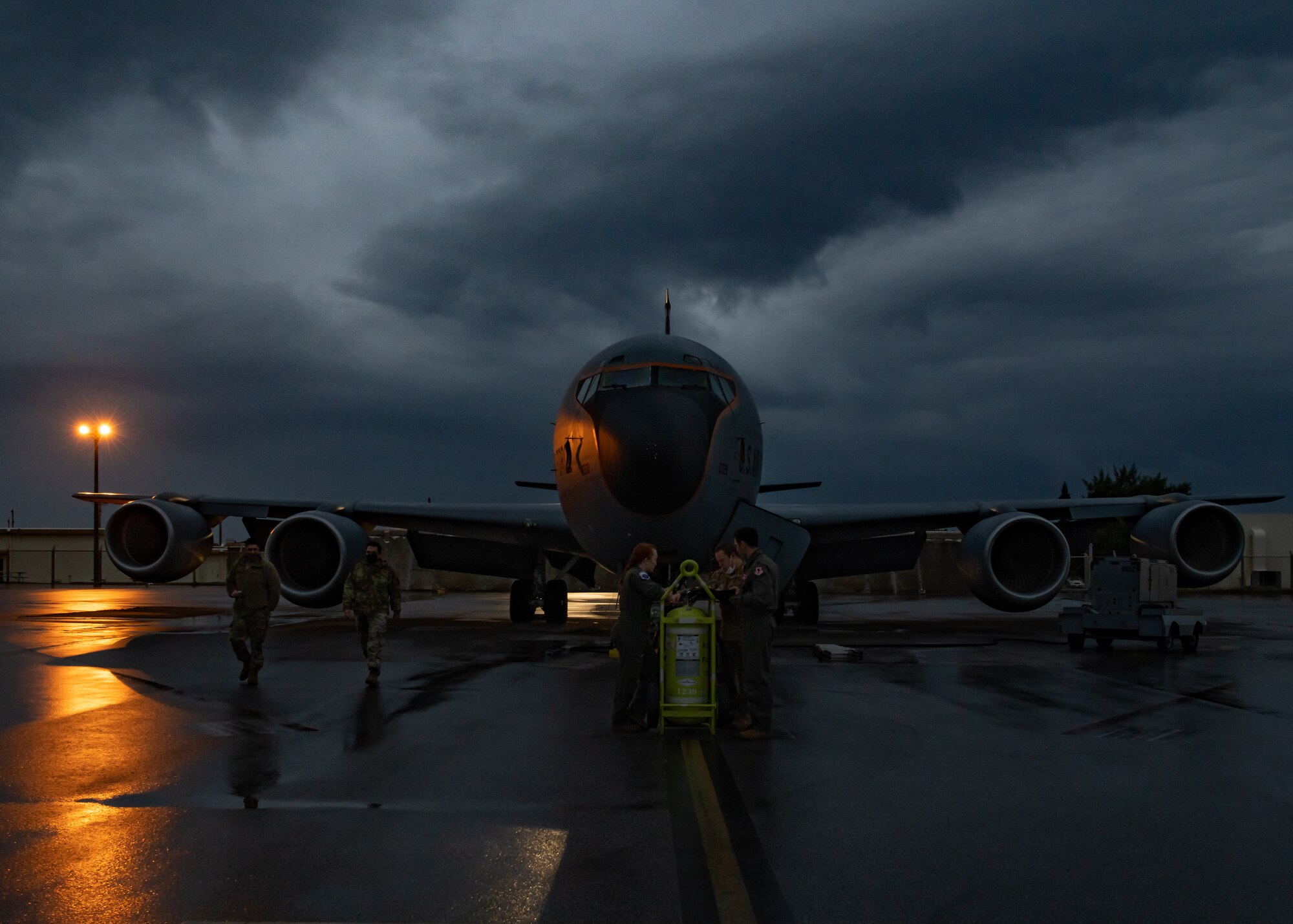 Aircrew members from the 909th Air Refueling Squadron conduct a pre-flight briefing in front of a U.S. Air Force KC-135 Stratotanker