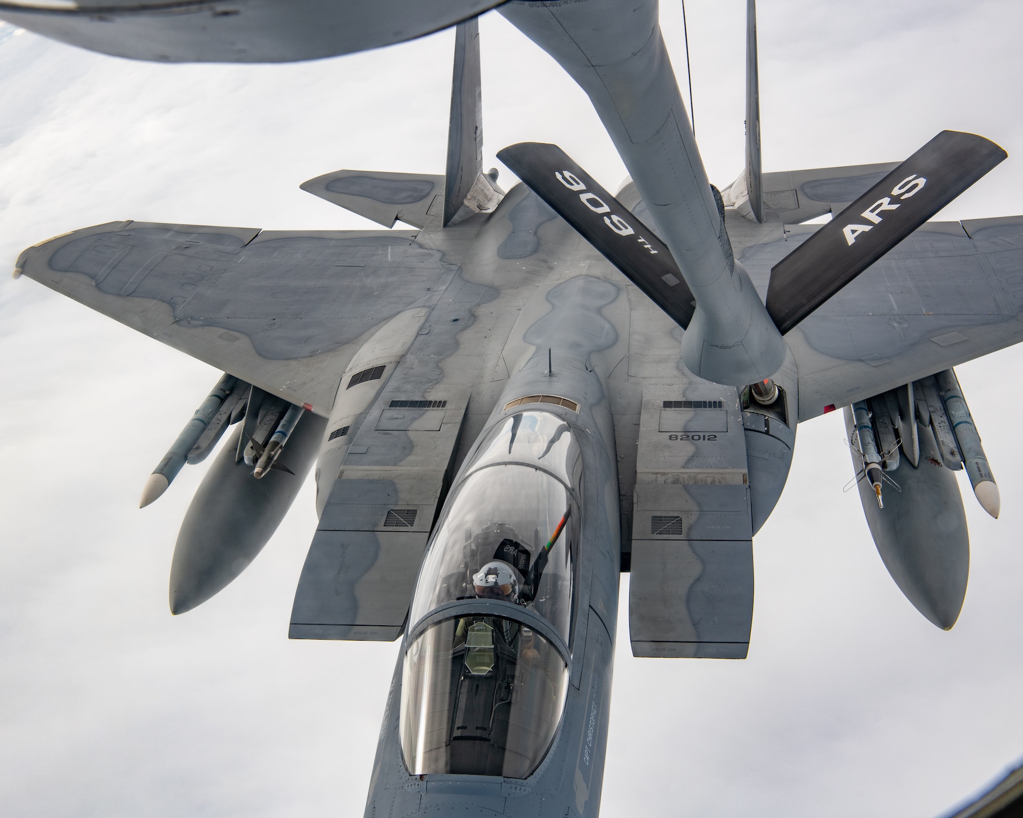 A U.S. Air Force F-15C Eagle receives fuel from a KC-135 Stratotanker assigned to the 909th Air Refueling Squadron over the Pacific Ocean