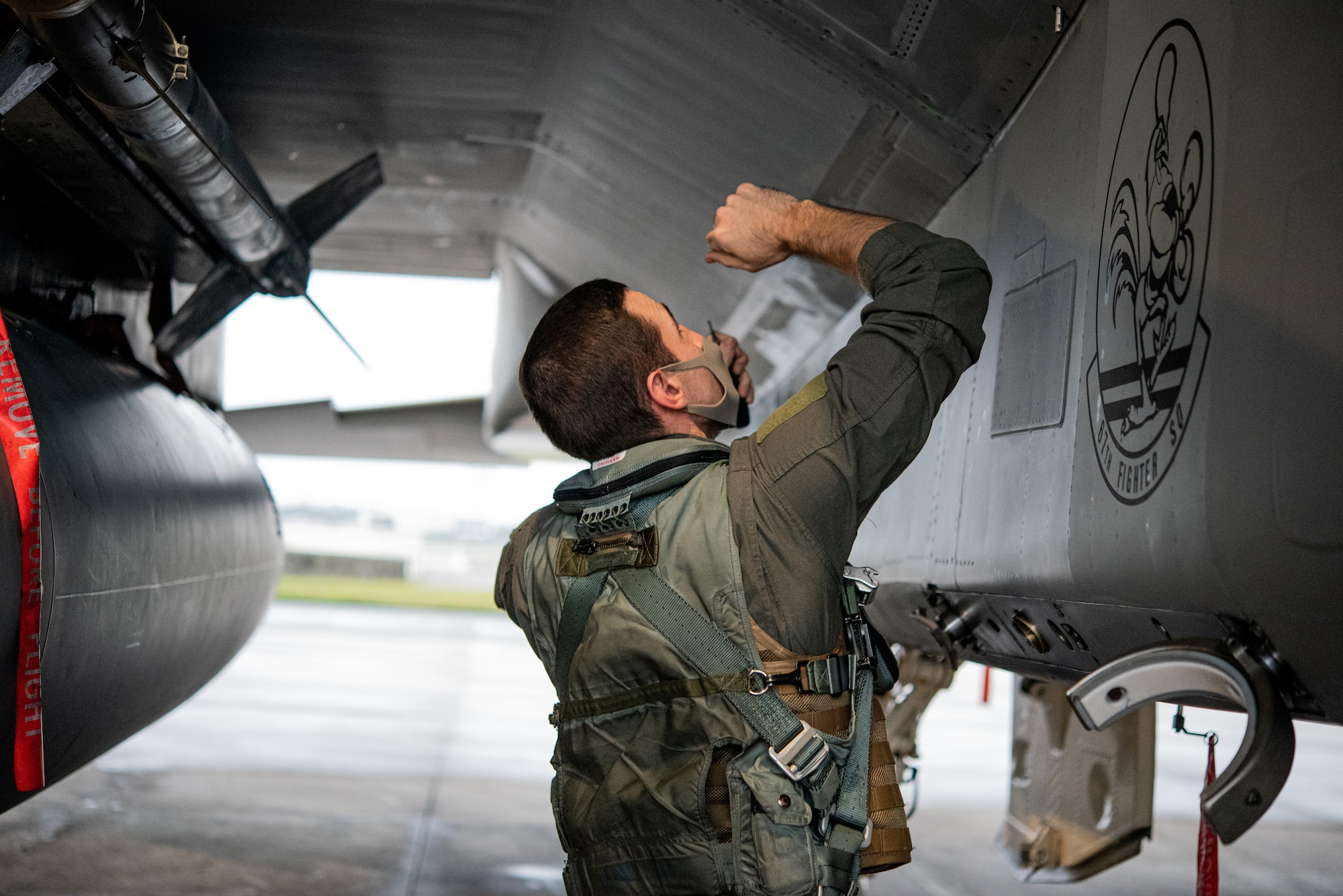 pilot performs pre-flight check