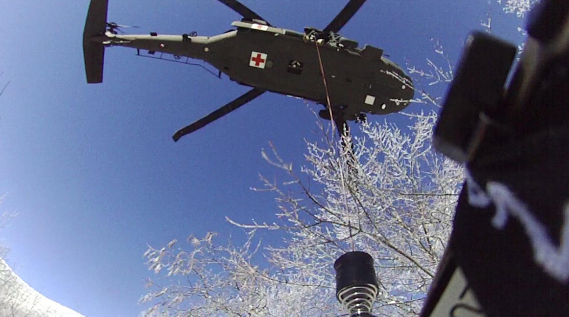 Tennessee National Guard Sgt. Chris Farrar lowers Sgt. 1st Class Tracy Banta, a critical care flight paramedic, to a stranded hiker on the Appalachian Trail in Great Smoky Mountains National Park Jan. 18, 2022.