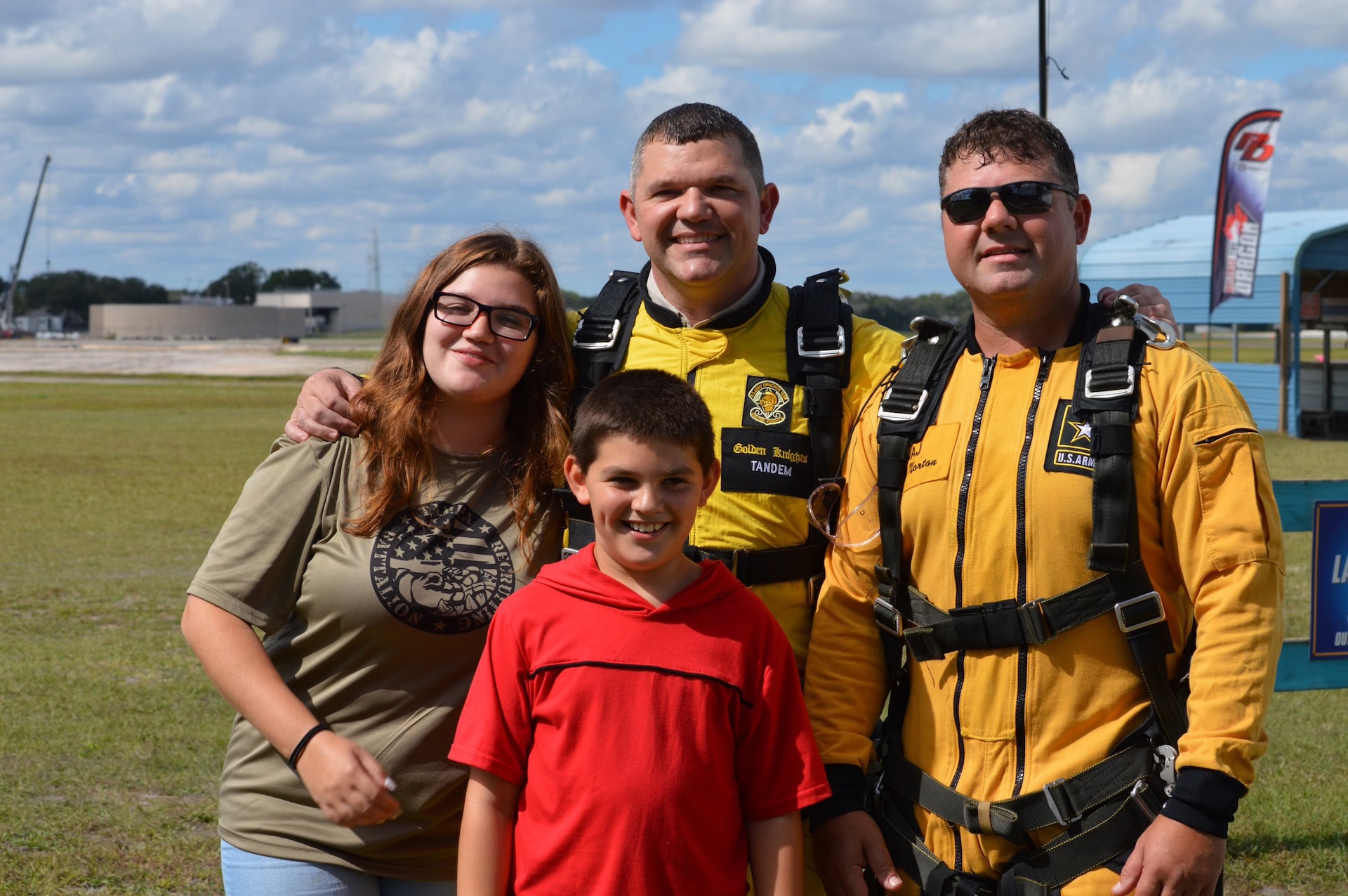 two men in tandem jump yellow uniforms