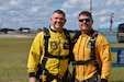 two men in tandem jump yellow uniforms