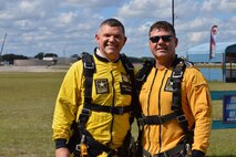 two men in tandem jump yellow uniforms