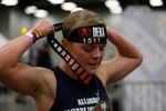 U.S. Army Maj. Samantha Wood, a medical specialist officer with Joint Forces Headquarters, California National Guard, places her medal around her neck after crossing the finish line of the Spartan DEKA FIT, a fitness competition that consists of 10 events, each preceded by a 500-meter run, in Austin, Texas, Jan. 15, 2022. Wood placed first overall among the National Guard women competing for a spot on the All Guard team.