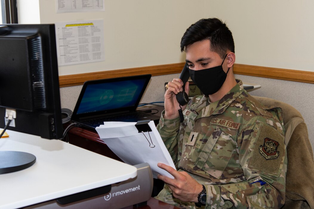 First Lt. Benjamin Pico, 436th Airlift Wing assistant staff judge advocate, reviews paperwork over the phone with clients during Super Wills Day at Dover Air Force Base, Delaware, Jan. 14, 2022. SJA personnel innovated Super Wills Day as a safe way to conduct legal services while adhering to COVID-19 guidelines and social distancing measures to reduce the spread of the disease. (U.S. Air Force photo by Roland Balik)