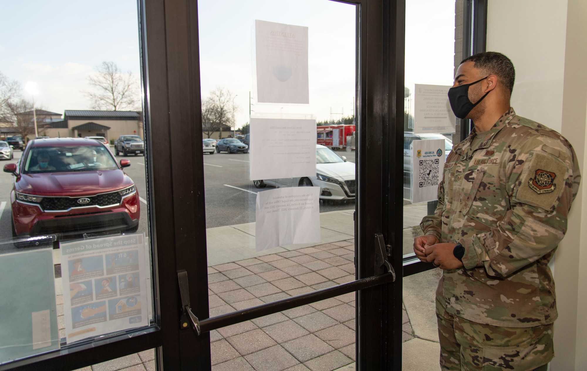 Staff Sgt. Shaan Shaffeeullah, 436th Airlift Wing Staff Judge Advocate military justice noncommissioned officer in charge, scans the parking slots where clients review their legal documents in their vehicle on Dover Air Force Base, Delaware, Jan. 14, 2022. SJA personnel innovated Super Wills Day as a safe way to conduct legal services while adhering to COVID-19 guidelines and social distancing measures to reduce the spread of the disease. (U.S. Air Force photo by Roland Balik)