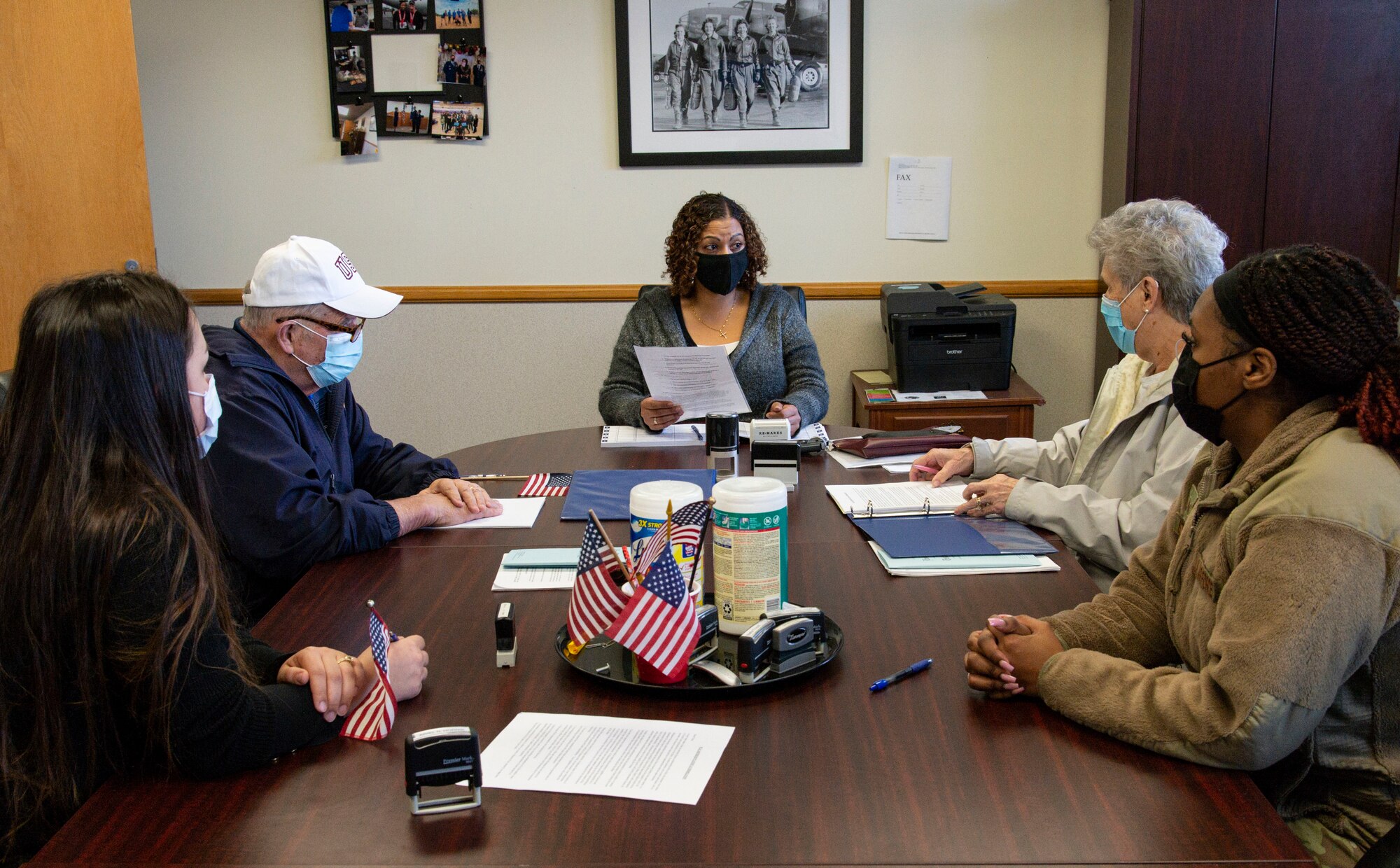 Charlotte Miceli, center, 436th Airlift Wing Staff Judge Advocate legal assistant, discusses legal documents with retired Senior Master Sgt. Robert Knehnl, far left, and his wife Yvonne, far right, during Super Wills Day at Dover Air Force Base, Delaware, Jan. 14, 2022. The SJA office was forced to alter and limit available services due to current COVID-19 guidelines and social distancing measures. (U.S. Air Force photo by Roland Balik)