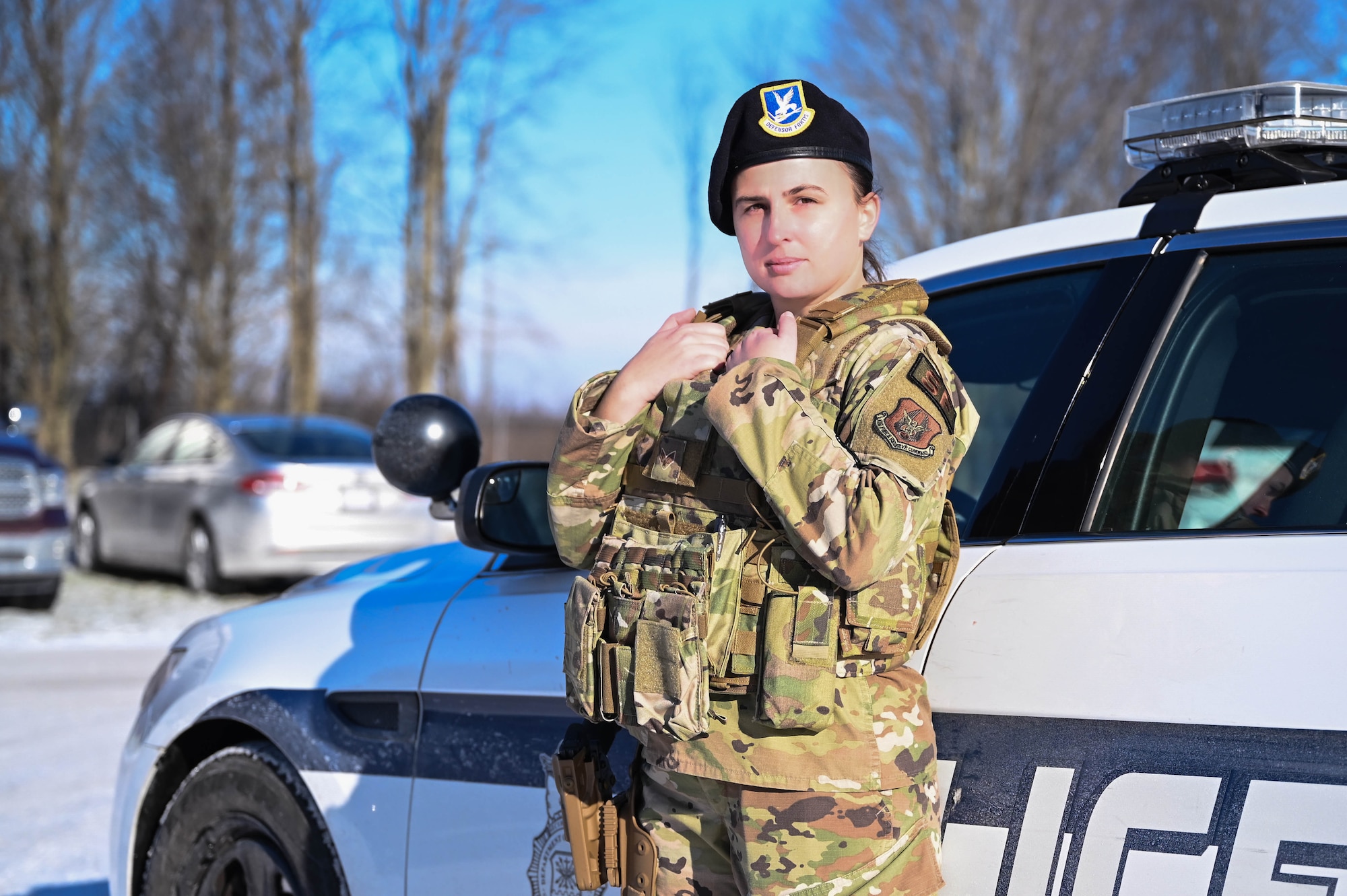 Senior Airman Viktoria Senkiv, a fireteam member assigned to the 910th Security Forces Squadron, poses for a photo beside a 910th SFS interceptor vehicle, Jan. 8, 2022.