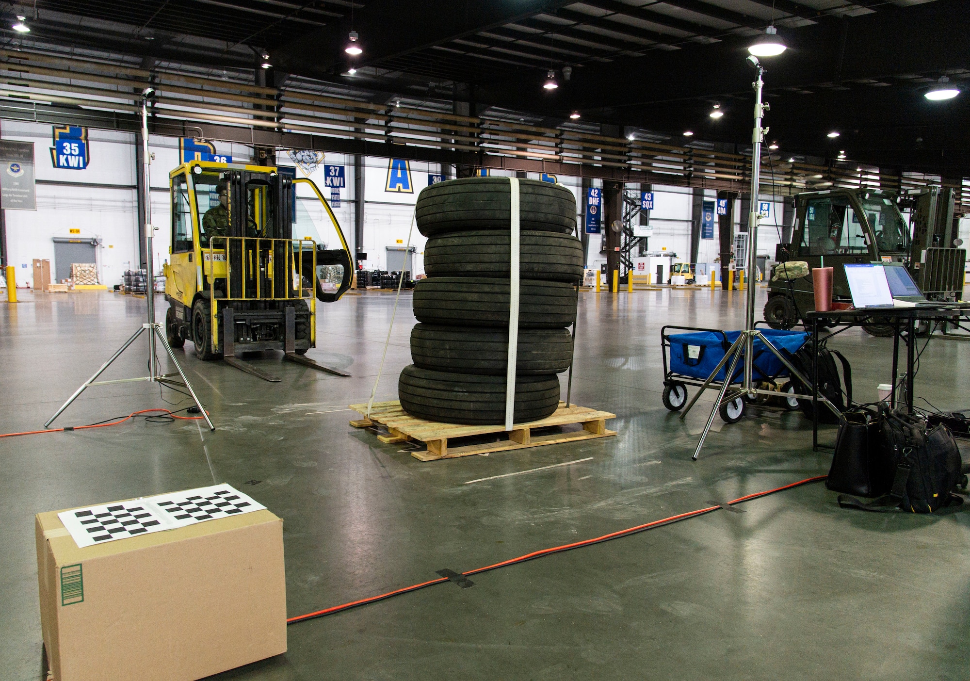 The Configured Air Load Building Tool system scans a pallet of tires during testing on Dover Air Force Base, Delaware, Nov. 17, 2021. In an effort to modernize the 2T2 career field as part of the Aerial Port of the Future initiative, the 436th Aerial Port Squadron was selected for CALBT testing due to its location and daily cargo movement. (U.S. Air Force photo by Roland Balik)