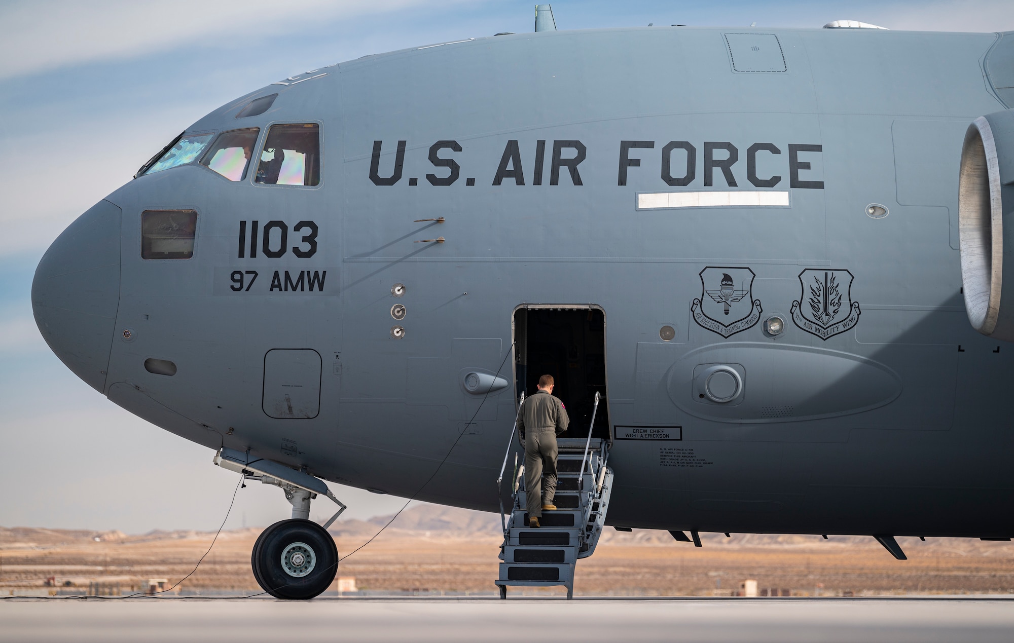 man walks up stairs into a large airplane