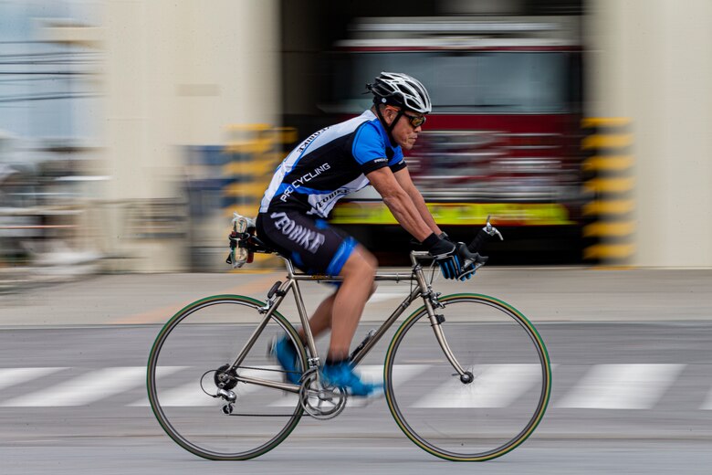 Masami Goya, a fire captain with Marine Corps Installations Pacific Fire and Emergency Services (MCIPAC F&ES), commutes on his bicycle on Camp McTureous, Okinawa, Japan, Jan. 10, 2022. Goya has been a firefighter for MCIPAC F&ES since 1990, is an avid marathon, triathlon, and Ironman competitor and has been performing Shishimai, a Japanese traditional lion dance, for 41 years. (U.S. Marine Corps photo by Lance Cpl. Alex Fairchild)