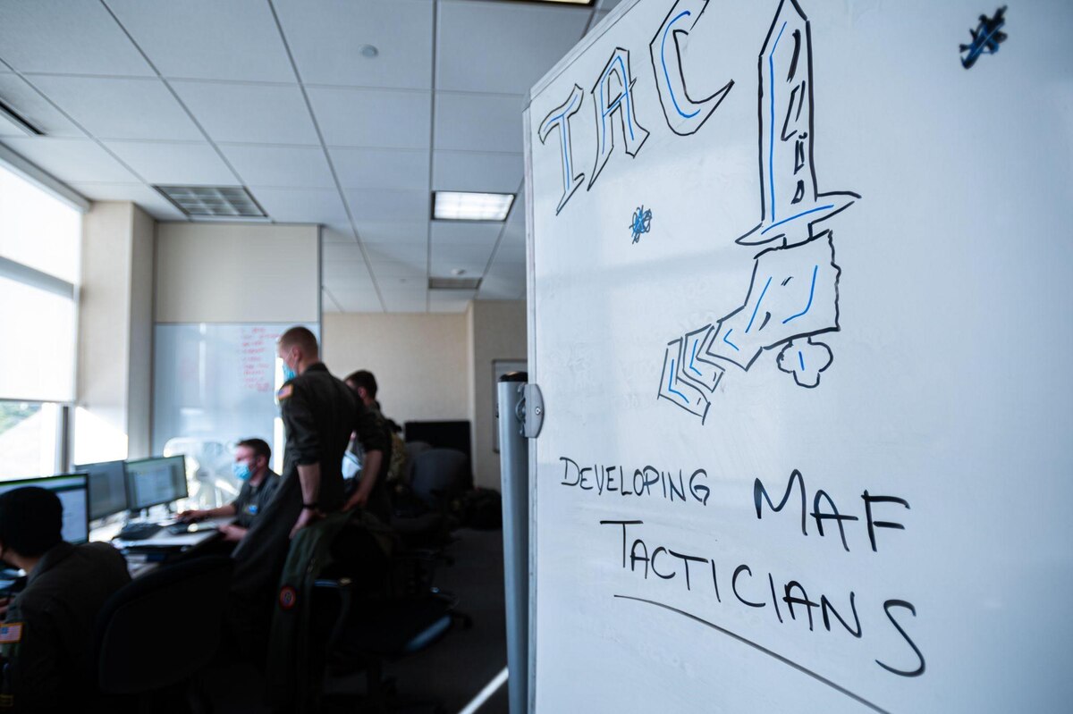 Whiteboard with graphic of arm with sword, with text saying "developing MAF tacticians"