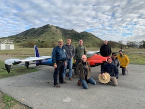 Dr. Stephen Ellis, Air Education and Training Command’s Detachment 62, Parker Downey, Kitty Hawk, Capt. Terrence McKenna, Agility Prime, Brittney Tough, Kitty Hawk, Lt. Col. Andrew Anderson, AETC’s Det. 62, Eric Miller, Kitty Hawk, Allan Austria, Kitty Hawk, Maj. Nicholaus Carrea, AETC’s Det. 62  stand in front of an electric Vertical Takeoff and Landing aircraft at the Kitty Hawk Corporation’s facility in Palo Alto, Calif. The AFWERX Agility Prime program took another step forward in December with the first government remotely piloted flight of an eVTOL aircraft. (Courtesy photo)