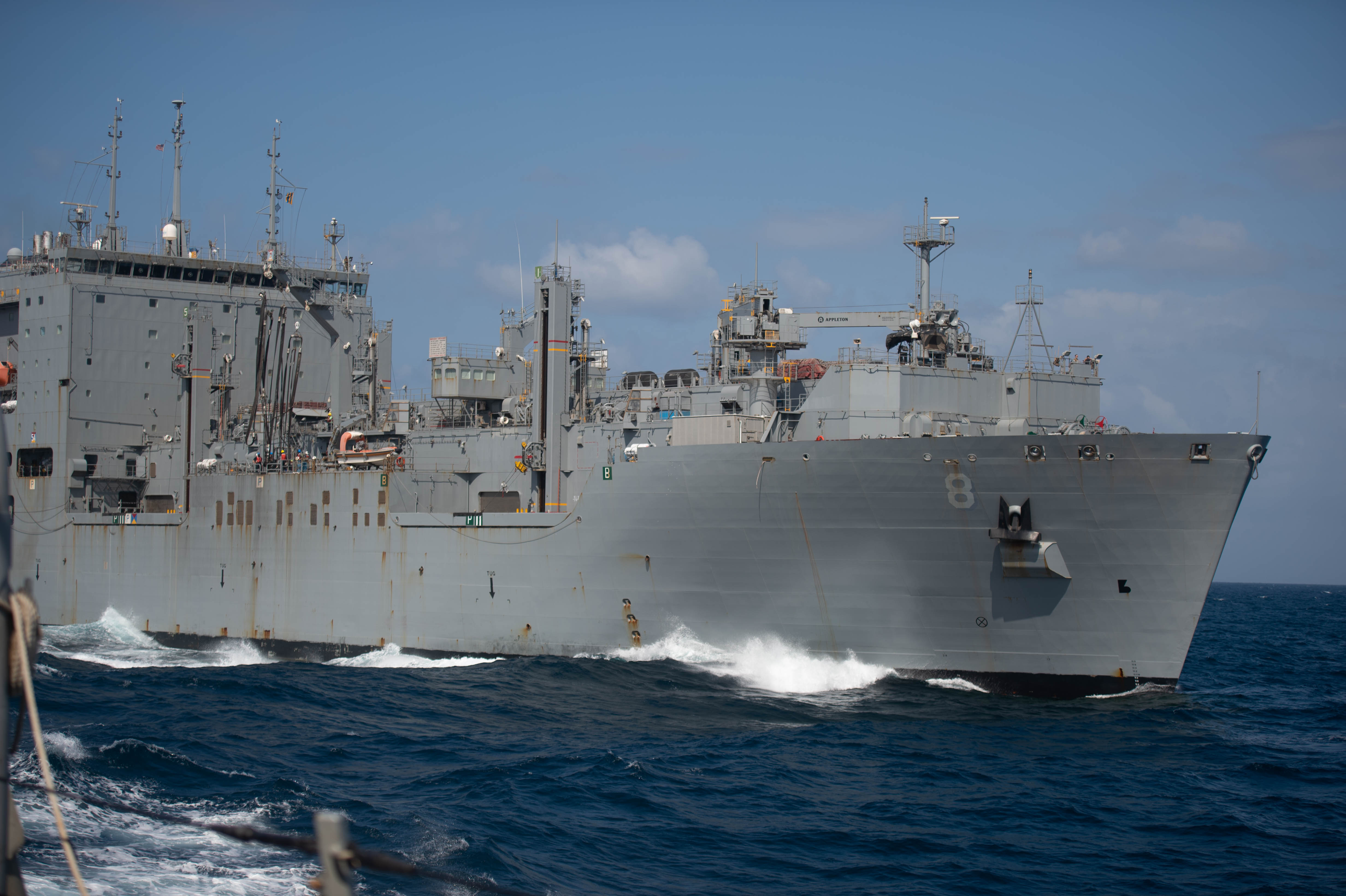 Dry-cargo ship USNS Wally Schirra (T-AKA-8) transits alongside guided-missile destroyer USS Jason Dunham (DDG 109) during a replenishment at sea, Jan. 9, 2022.