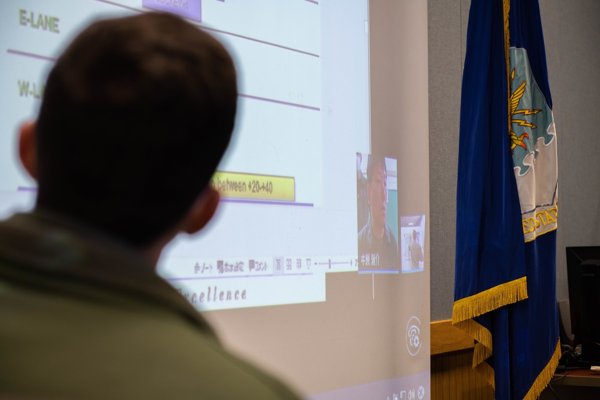 A U.S. Air Force captain attends a planning briefing as a member of the Japan Air Self-Defense Force goes over plans for the exercise Southern Beach 22-2 at Kadena Air Base, Japan, Jan. 18, 2022. The planning for Southern Beach usually takes place with members from both the USAF and JASDF meeting in one room, but due to COVID-19 it took place virtually. (U.S. Air Force photo by Airman 1st Class Cesar J. Navarro)