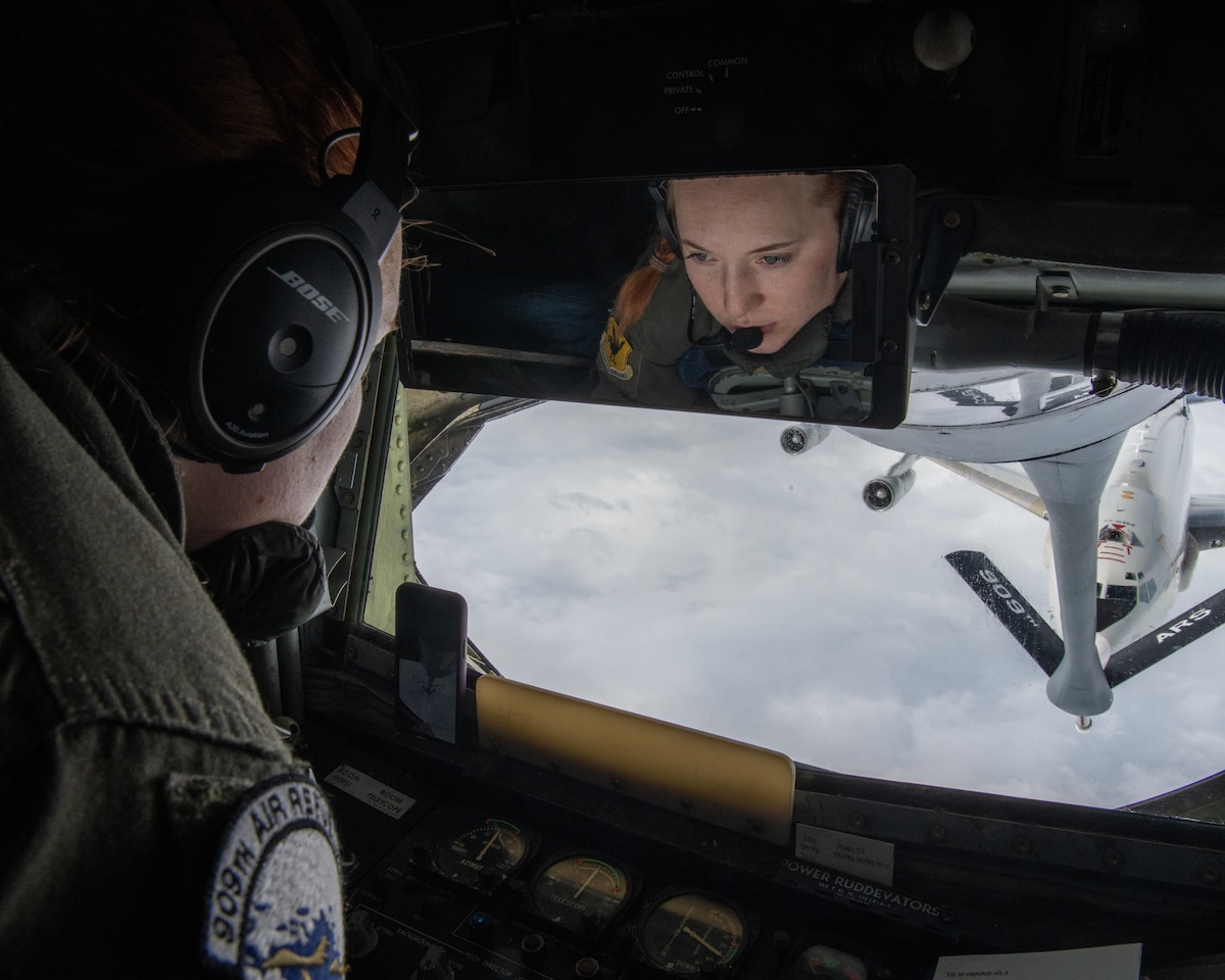 Staff Sgt. Samantha Grendahl, 909th Air Refueling Squadron boom operator, prepares to refuel an approaching U.S. Air Force E-3G Sentry over the Pacific Ocean during Exercise Southern Beach 22-2, Jan. 19, 2022. Bilateral training like Exercise Southern Beach is part of a continual effort to enhance interoperability between U.S. Forces and host nations, building a partnership that can effectively operate high-end missions in defense of a free and open Indo-Pacific region. (U.S. Air Force photo by Airman 1st Class Anna Nolte)