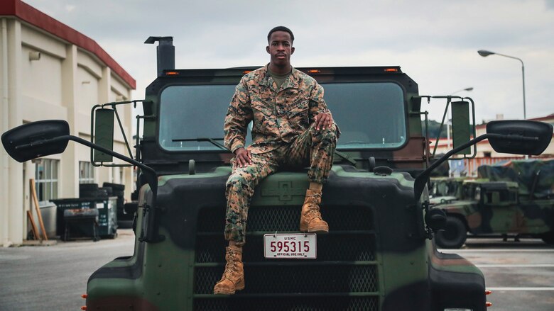 U.S. Marine Corps Pfc. Benjamin Crayton, a motor vehicle operator with Headquarters and Support Battalion, Marine Corps Installations Pacific, poses for a photo on Camp Foster, Okinawa, Japan, Jan. 10, 2022. Crayton was born in Monrovia, Liberia during the First Liberian Civil War, and immigrated to Europe as a refugee. When he was 17 years old he moved to the U.S. and in 2021 he enlisted in the Marine Corps. (U.S. Marine Corps photo by Lance Cpl. Jonathan Beauchamp)