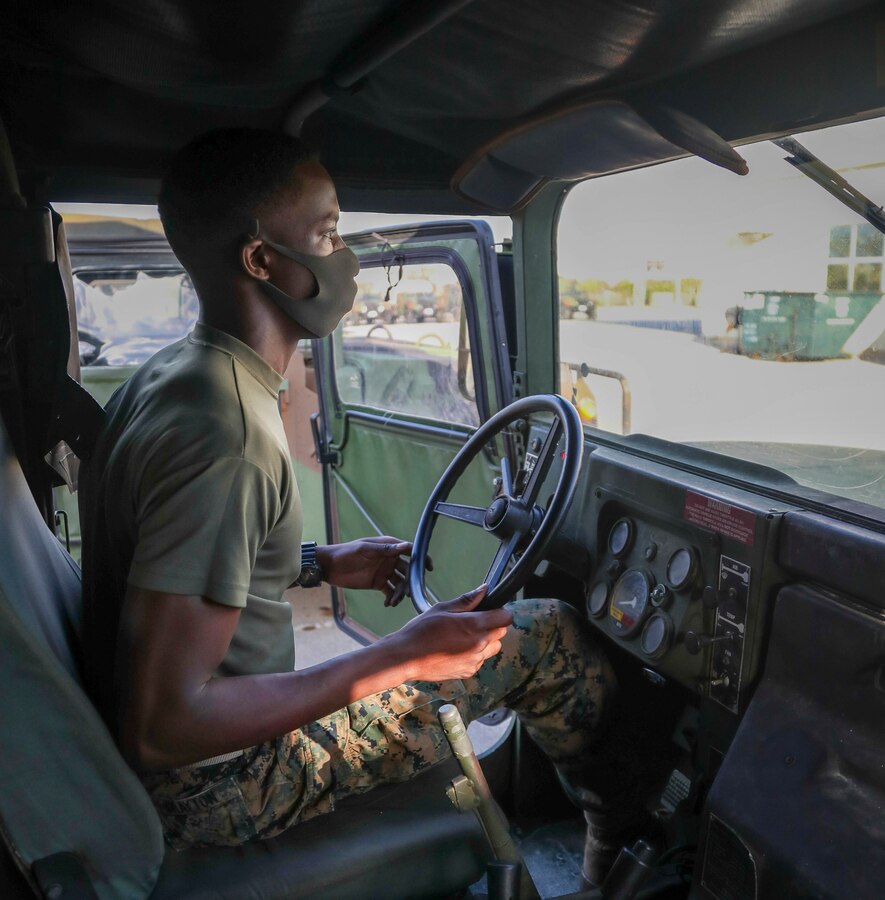 U.S. Marine Corps Pfc. Benjamin Crayton, a motor vehicle operator with Headquarters and Support Battalion, Marine Corps Installations Pacific, follows hand and arm signals during an inspection of a Humvee on Camp Foster, Okinawa, Japan, Jan. 10, 2022. Crayton was born in Monrovia, Liberia during the First Liberian Civil War, and immigrated to Europe as a refugee. When he was 17 years old he moved to the U.S. and in 2021 he enlisted in the Marine Corps. (U.S. Marine Corps photo by Lance Cpl. Jonathan Beauchamp)