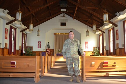 Chaplain (Lt. Col.) Schaun Myers, Pennsylvania National Guard Joint Force Headquarters chaplain, poses inside the main post chapel at Fort Indiantown Gap, Pa., on Jan. 19, 2022.