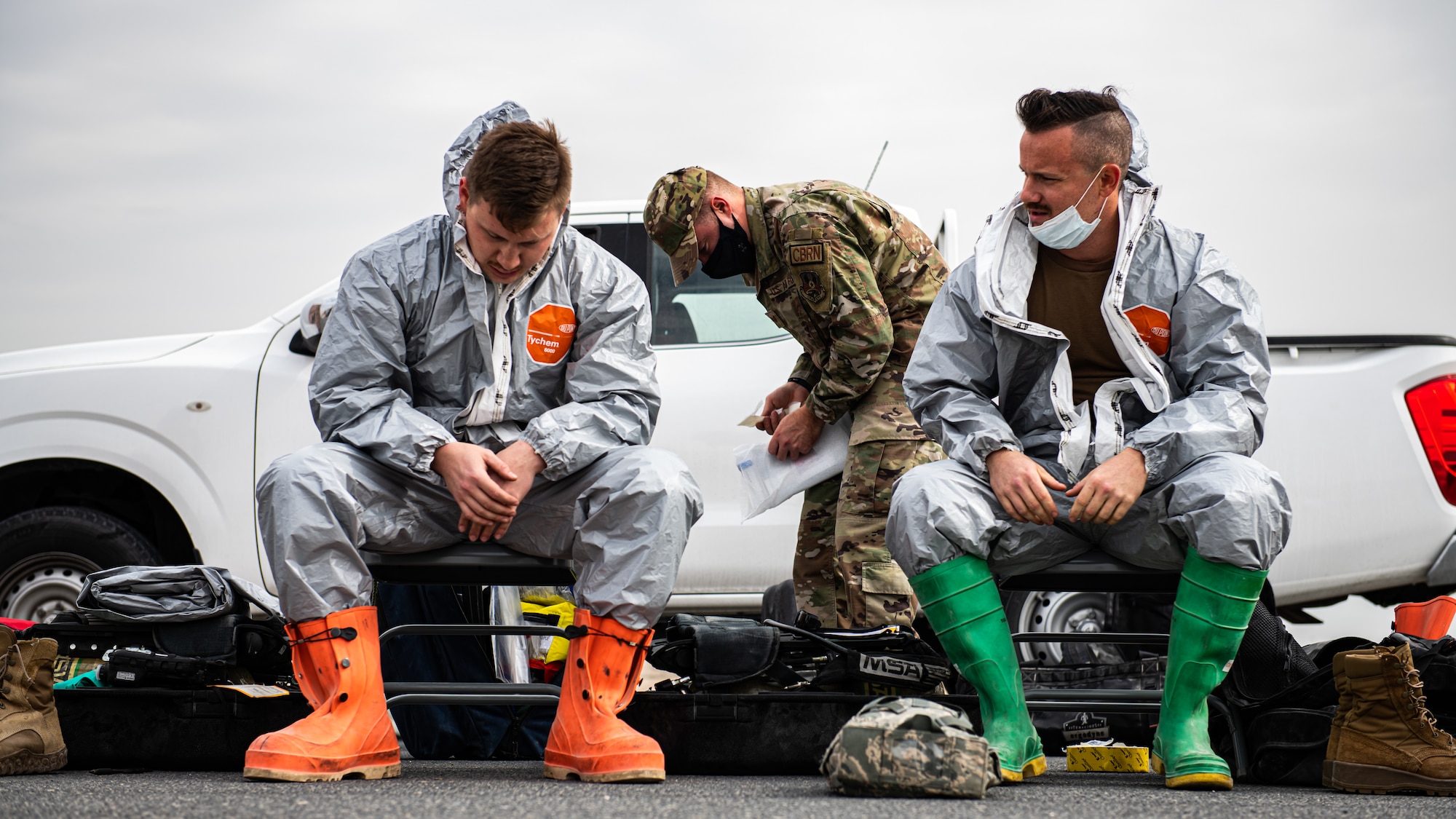 Airmen sit in chairs.