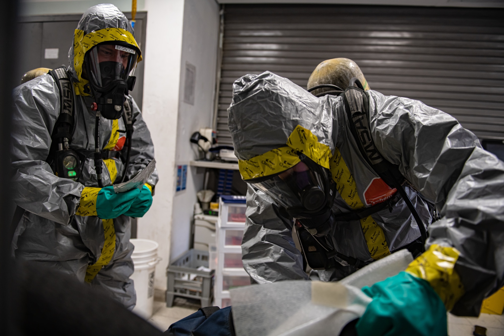 Airmen retrieve gear from a bag.