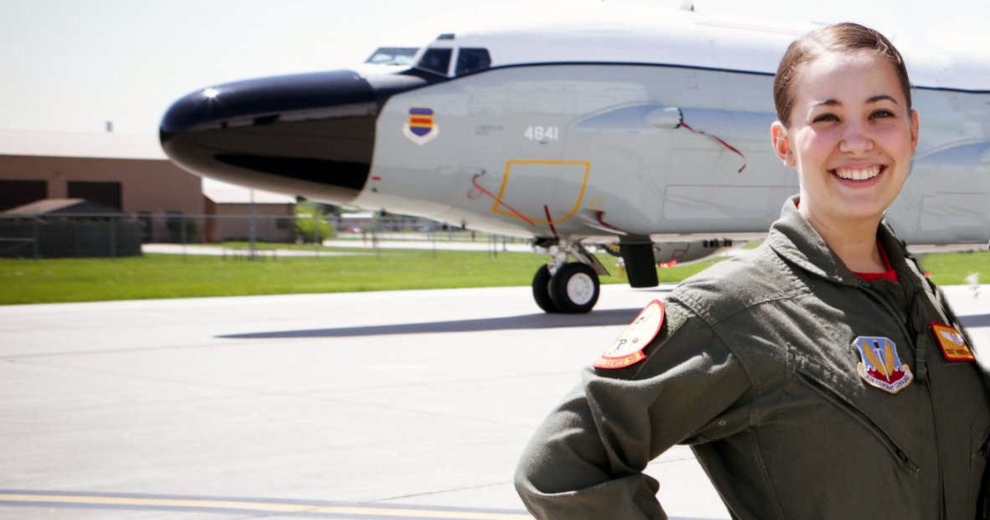 Image of Airman posing for a photo in front of a plane.