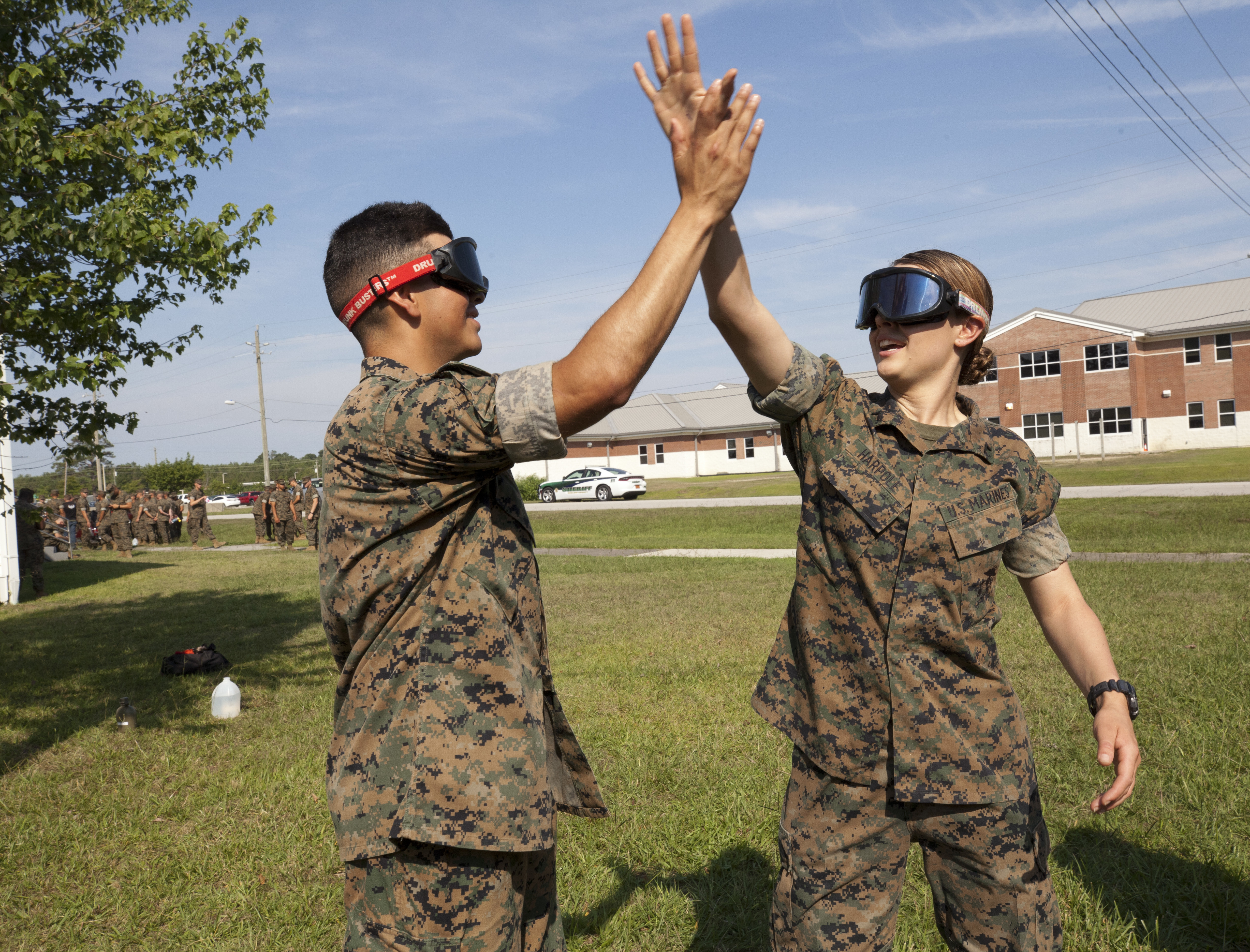 Two Marines high-fiving outside.