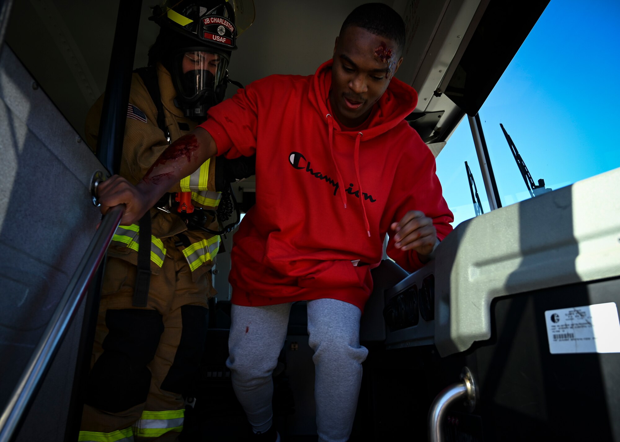 A volunteer is escorted off of a bus during a mass casualty exercise at Shaw Air Force Base, South Carolina, Jan. 19, 2022. The purpose of the exercise was to enhance and build on each agency's readiness capabilities for quick response emergencies. (U.S. Air Force photo by Senior Airman Madeline Herzog)