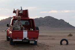 Member of the Royal Saudi Armed Forces sits in back of a truck