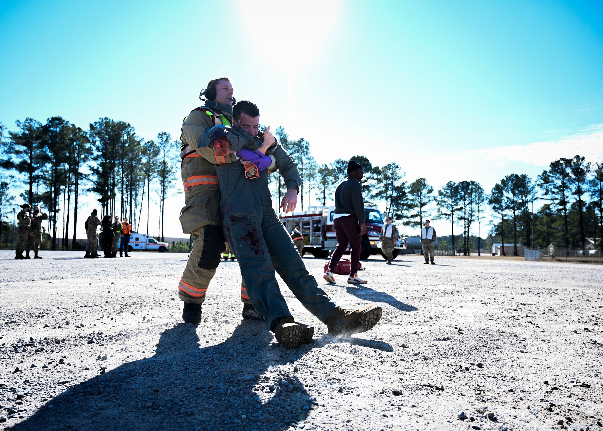 An Airman assigned to the 20th Civil Engineer Squadron fire department drags an injured volunteer out of a simulated car crash during a mass casualty training exercise at Shaw Air Force Base, South Carolina, Jan. 19, 2022. The two-day exercise was designed to test and enhance the capabilities of multiple emergency response personnel. (U.S. Air Force photo by Senior Airman Madeline Herzog)