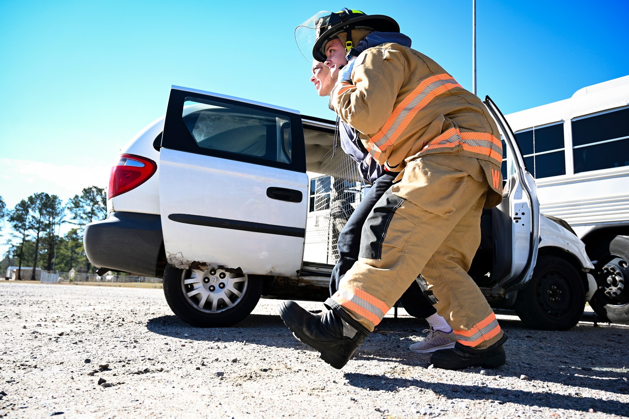 An Airman assigned to the 20th Civil Engineer Squadron fire department carries an injured volunteer out of a car crash during a mass casualty training exercise at Shaw Air Force Base, South Carolina, Jan. 19, 2022. The purpose of the mass casualty exercise was to enhance and build on each agency's readiness and posture for quick response emergencies. (U.S. Air Force photo by Senior Airman Madeline Herzog)