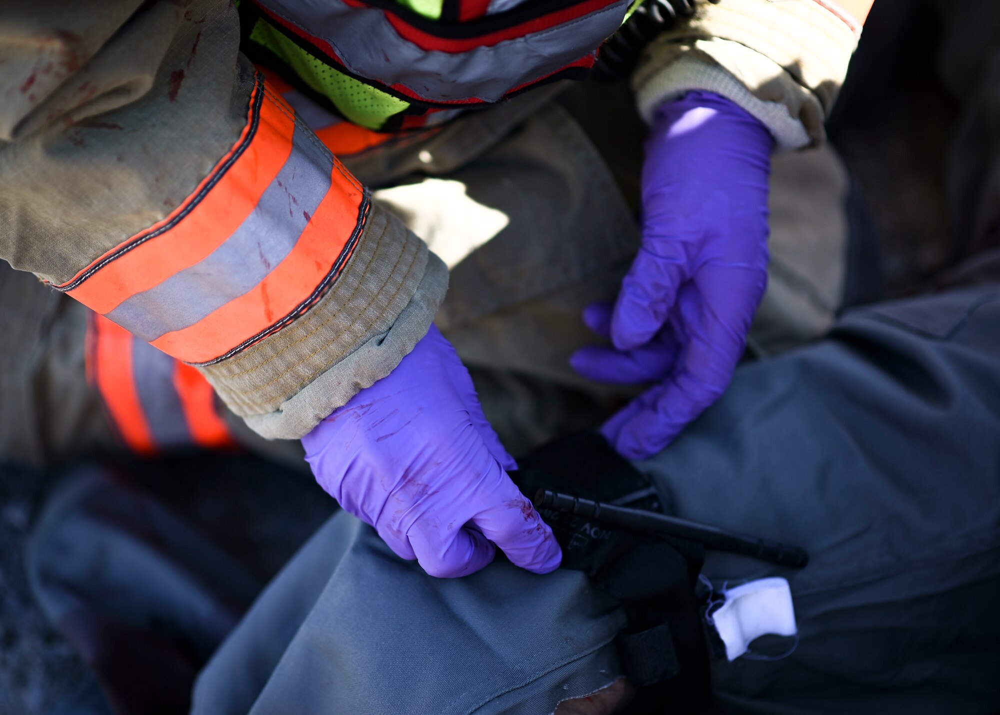 An emergency response Airman performs triage on an injured volunteer during a mass casualty training exercise at Shaw Air Force Base, South Carolina, Jan. 19, 2022. The purpose of the exercise was to enhance and build on each agency's readiness capabilities for quick response emergencies. (U.S. Air Force photo by Senior Airman Madeline Herzog)