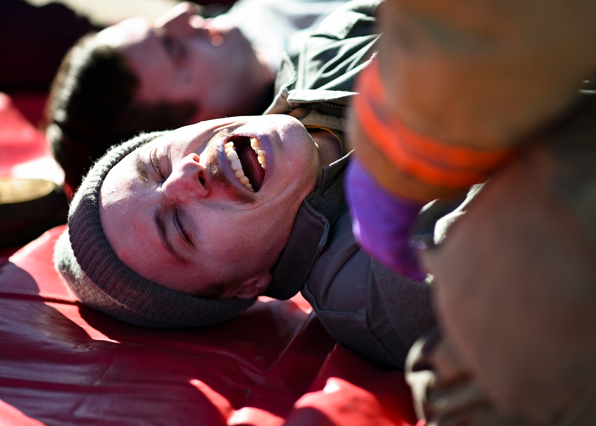 A volunteer yells out in pain during a mass casualty exercise at Shaw Air Force Base, South Carolina, Jan. 19, 2022. The exercise involved a three vehicle collision with simulated injuries and 19 volunteers acting as if they were in the accident. (U.S. Air Force photo by Senior Airman Madeline Herzog)