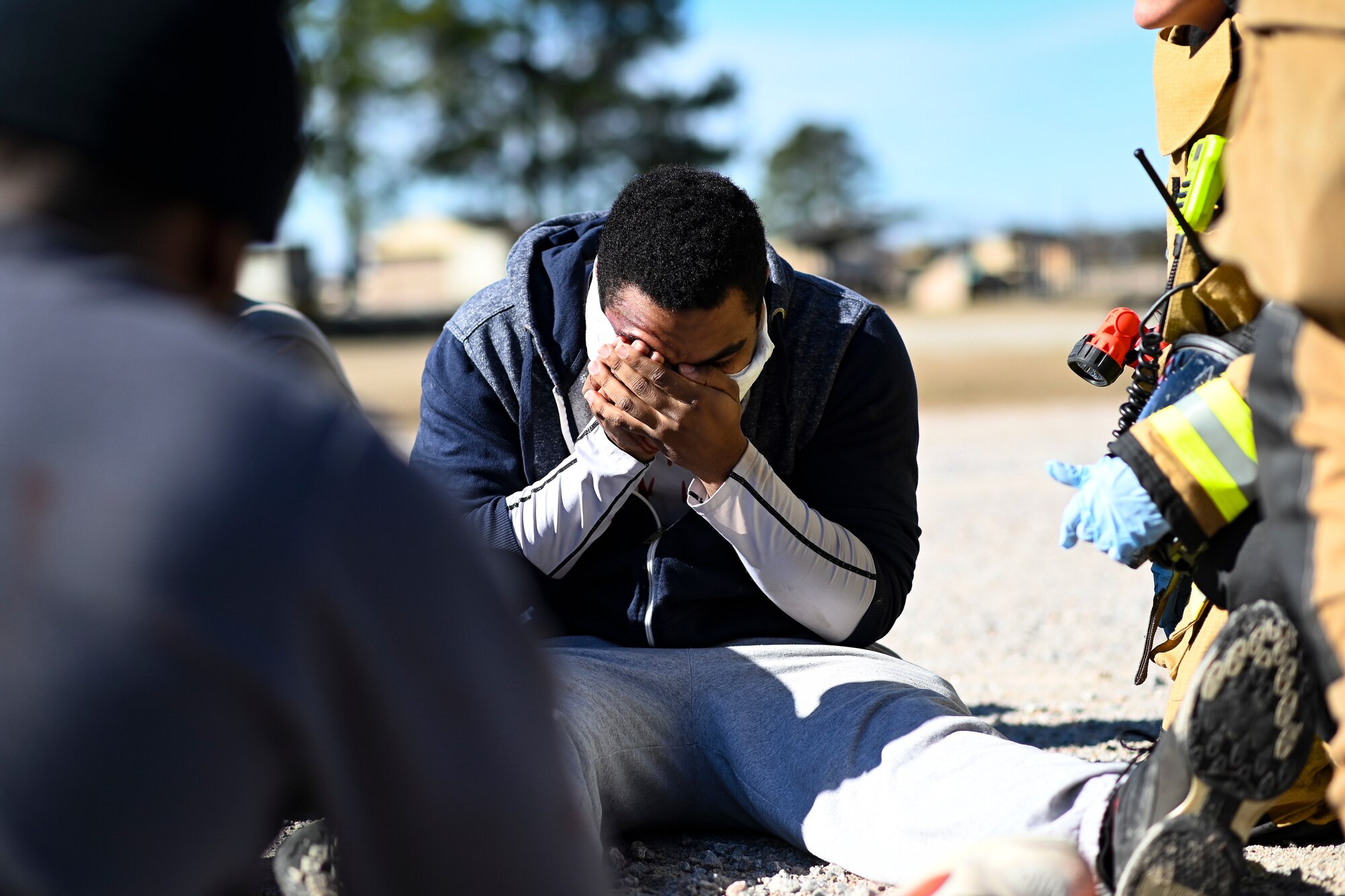 An injured volunteer is treated during a mass casualty exercise at Shaw Air Force Base, South Carolina, Jan. 19, 2022. The exercise involved a three vehicle collision with simulated injuries and 19 volunteers acting as if they were in the accident. (U.S. Air Force photo by Senior Airman Madeline Herzog)