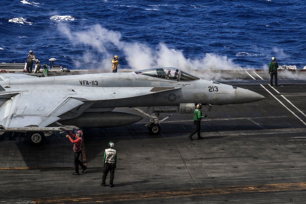 An F/A-18E Super Hornet, assigned to the "Stingers" of Strike Fighter Squadron (VFA) 113, taxis across the flight deck of the Nimitz-class aircraft carrier USS Carl Vinson (CVN 70), Jan. 20, 2022.