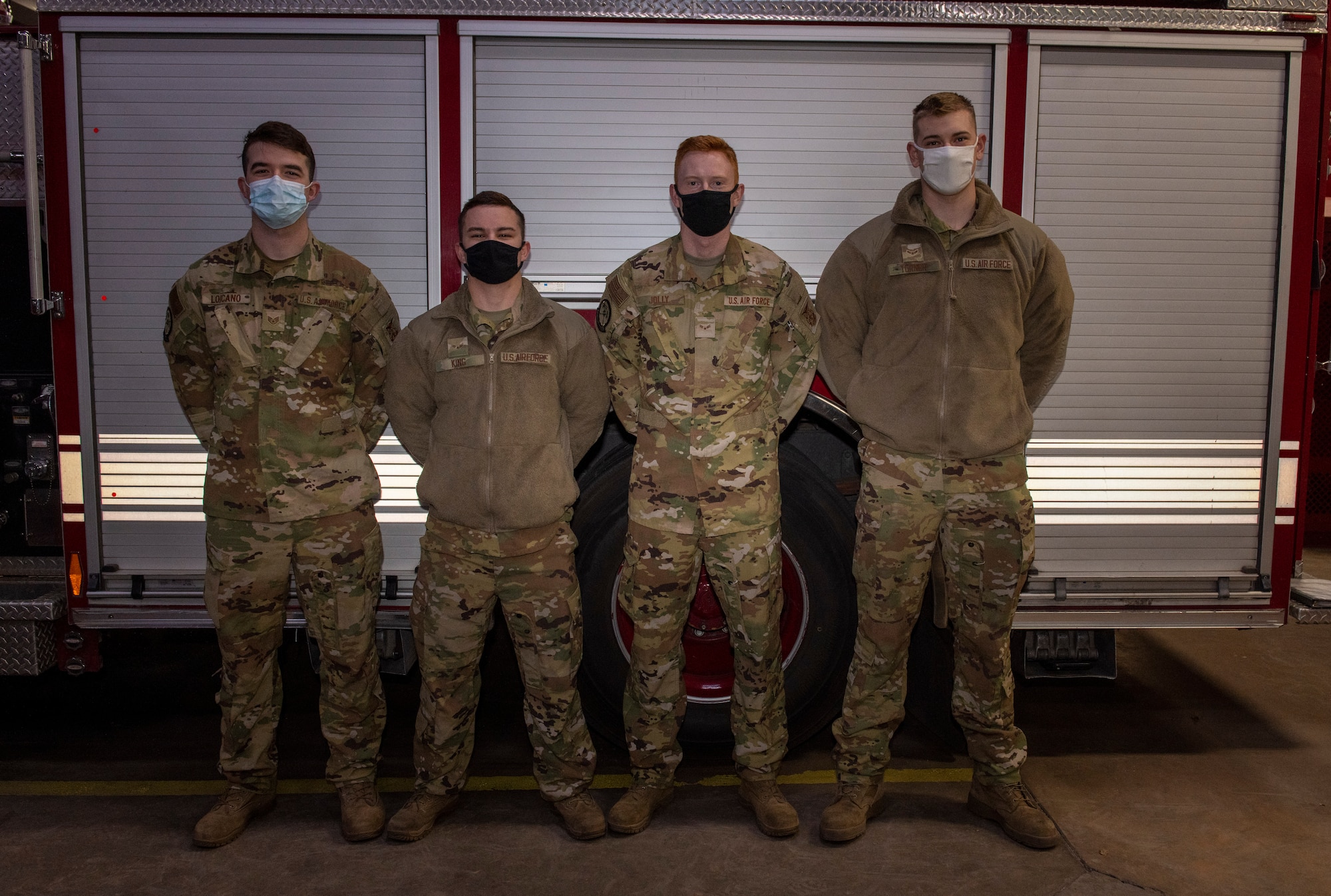 Staff Sgt. Charles Loicano, Airman 1st Class Matyas King, Airman 1st Class Austin Jolly and Airman 1st Class Joshua Turner from the 97th Civil Engineer Squadron Fire and Emergency Services Flight pose at Altus Air Force Base, Oklahoma, Jan. 17, 2022. The Airmen were awarded with life-saving certificates signed by the Air Force fire chief. (U.S. Air Force photo by Airman 1st Class Miyah Gray)