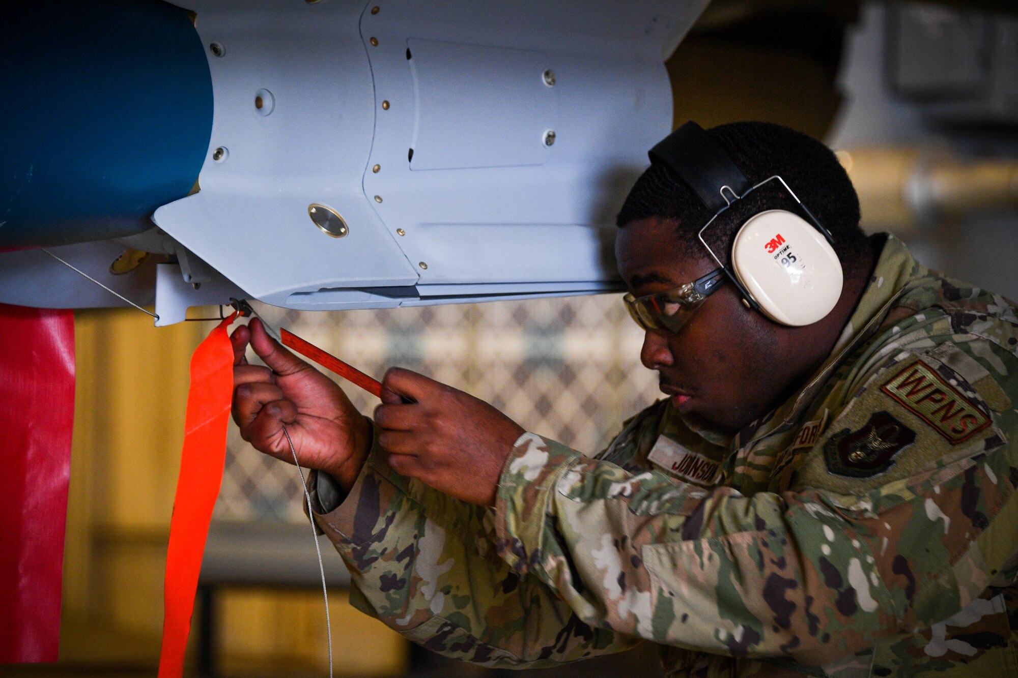 Senior Airman Keyshawn Johnson, 301st Fighter Wing Aircraft Maintenance Squadron weapons load crew member, checks for safety proficiency at Naval Air Station Joint Reserve Base Fort Worth, Texas, Jan. 9, 2022. Throughout the year weapons crews are put to the test of safely loading and unloading ordinances to their respective aircraft in front of their peers while being timed.